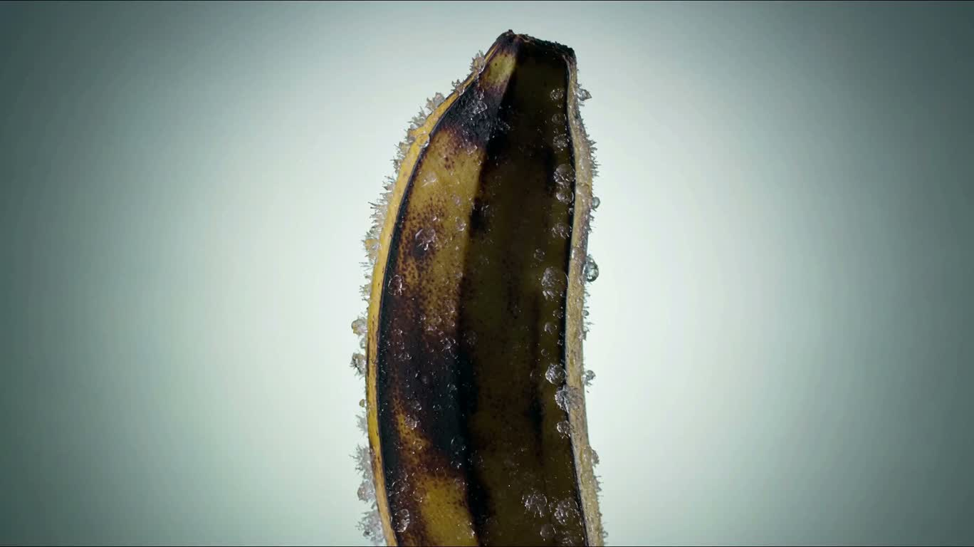 얼어붙은 바나나가 스스로 껍질을 벗는 초현실적 클로즈업